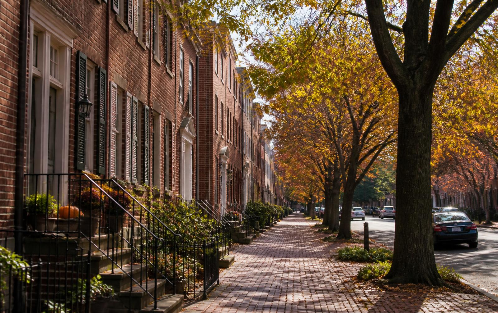 Historic brick rowhouses on a York Pennsylvania street in autumn
